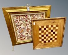 An ornate gilt-framed firescreen with an inset floral tapestry panel.