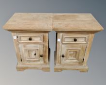 A pair of stripped pine bedside cabinets fitted with a drawer.