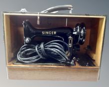 A 20th century Singer electric sewing machine, in case.