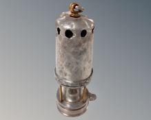 A late 19th century miner's lamp. CONDITION REPORT: Original finish removed.