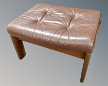 A 20th century footstool upholstered in brown button leather.