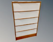 A 20th century white and teak five drawer chest.