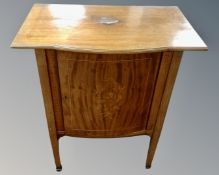 A 19th century inlaid mahogany shaped front cabinet on raised legs with marquetry panel door.