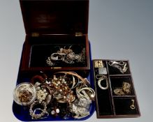 A hardwood brass inlaid jewellery casket containing a quantity of costume jewellery.