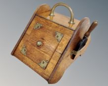 A 19th century oak coal receiver with liner and shovel.