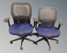 Two contemporary office adjustable swivel armchairs with fabric seats and mesh backs.