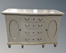 A Scandinavian painted oak double door break front sideboard on raised legs fitted with four