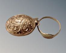 A small gold signet ring and a similar embossed locket.