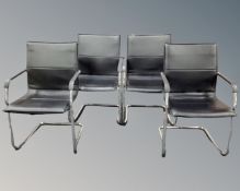 A set of four black leather tubular metal framed stacking office armchairs.