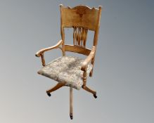 An Edwardian colonial swivel desk armchair.