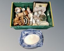 A crate containing Eastern wooden carvings, a pottery jelly mould,