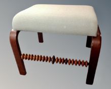 A Danish Skippers furniture footstool upholstered in a green fabric.