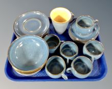 A tray of approximately 27 pieces of Denby blue glazed teacups and dinnerware.