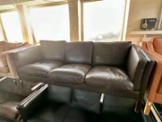 A Stouby three seater settee with brown leather cushions.