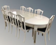 A 20th century painted oak oval extending dining table with three leaves (length 234cm),