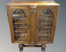 A 1930s carved oak double door bookcase.