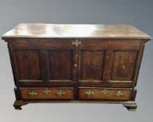 A George III oak panelled coffer fitted with two drawers beneath.