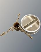 A mirrored cake stand together with a metal Christmas tree stand.