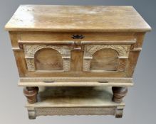 A Continental oak coffer on raised legs, locked.