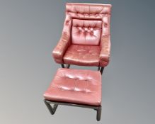 A 20th century Norwegian Stordal armchair with matching stool upholstered in red button leather.