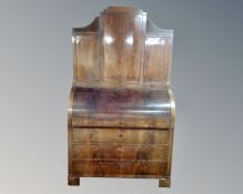 A 19th century Biedermeier cylinder bureau secretaire fitted with four drawers below and cupboards