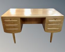 A mid-20th century Scandinavian teak twin pedestal desk on raised legs.