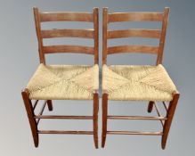 A pair of pine farmhouse rush seated ladderback chairs.