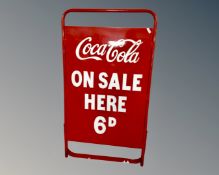 A folding metal A-frame bearing Coca-Cola on sale here 6d advertisement.