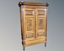A Continental mahogany double door cabinet on raised legs.