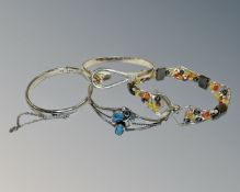 Four silver bracelets.