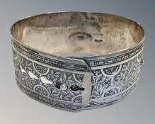 An antique silver bangle, diameter approx 6cm, band width 2.7cm.