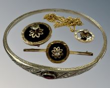 A 9ct gold bar brooch set with circular black onyx together with matching pendant and further