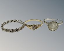 A 9ct yellow gold dress ring set with a small diamond chip, 1.