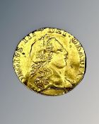 A 1762 gold quarter Guinea.