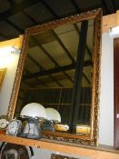 A large gilt framed bevel edged mirror. (Collect only)