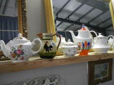 Four collectable teapots and a Totnes jug.