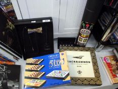 A boxed chess set, backgammon set, magnetic dart game, etc