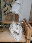 A table lamp with lover's on bench base.