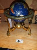 A jewelled globe on stand.