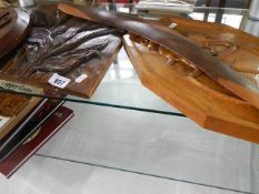 Four carved wood plaques.