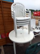 A white plastic garden set of round table & 4 chairs (table diameter 98cm). Collect Only.