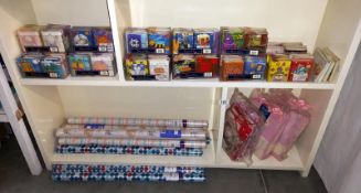 A selection of rolls of wrapping paper, gift bags and tags