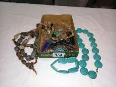 A tray of assorted natural stone pendants etc