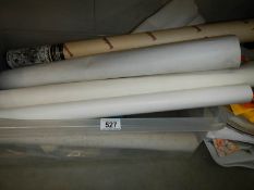 A crate of assorted rolled posters.