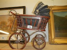 A small wicker dolls pram.