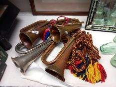 Three copper and one silver plate bugles.