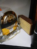 An art deco clock and a vintage radio.