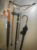 A quantity of walking sticks, shooting stick etc.,