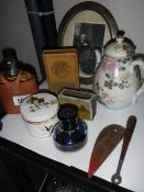 A tray of interesting items including a hip flask.