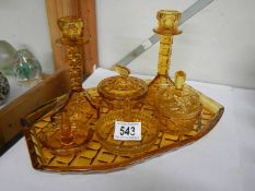 An amber glass trinket set, complete.
